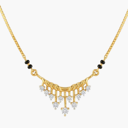 A gold chain necklace with a decorative pendant featuring small black beads and clear stones, shown on a plain white background.