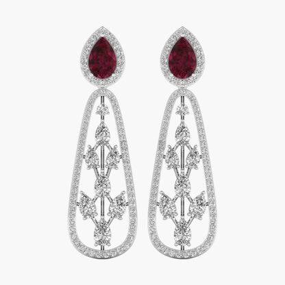Pair of earrings with red gemstones and silver designs on a white background
