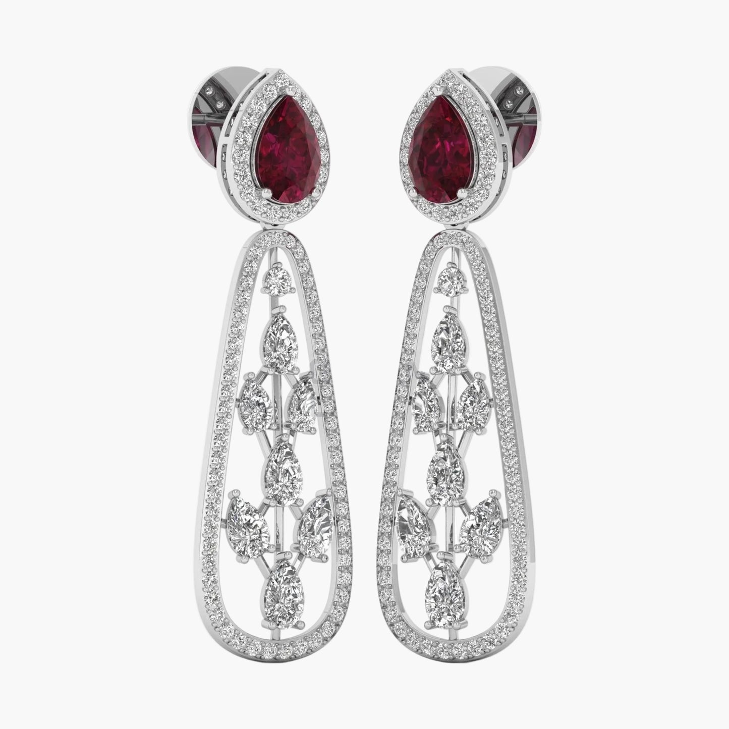 Pair of earrings with red gemstones and intricate silver designs on a white background