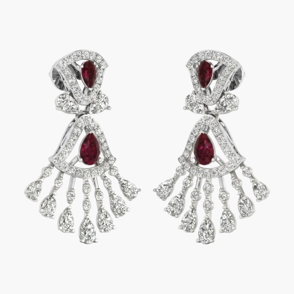 Pair of earrings with red gemstones and silver fringe on a white background