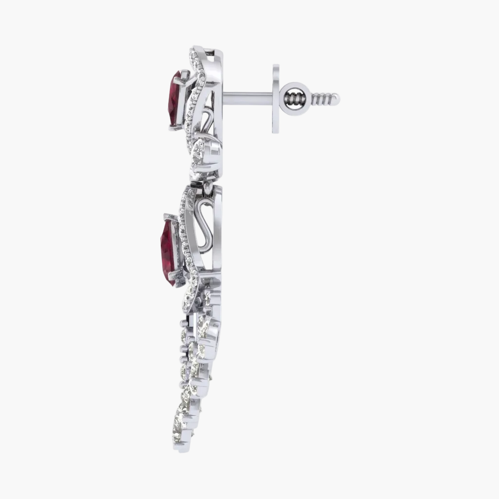 Silver earring with red gemstone and clear stones on a white background