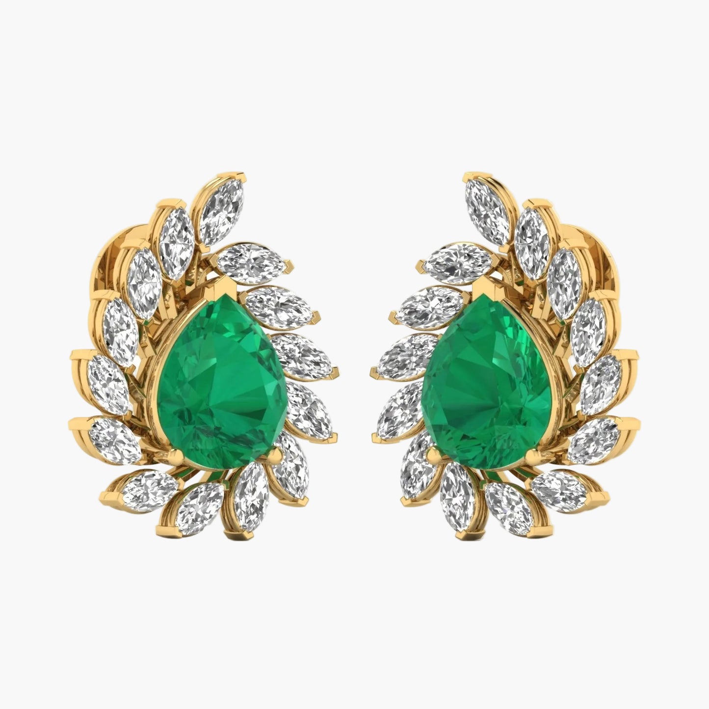 Gold earrings with green gemstones on a white background