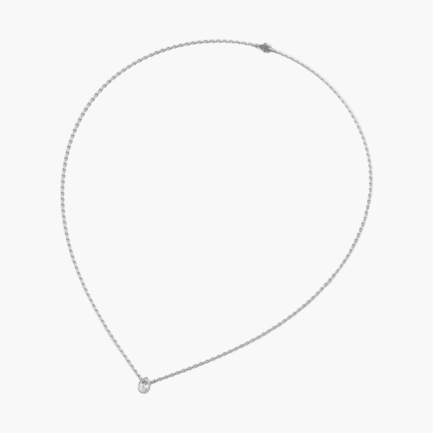 Silver necklace with a small round pendant on a white background