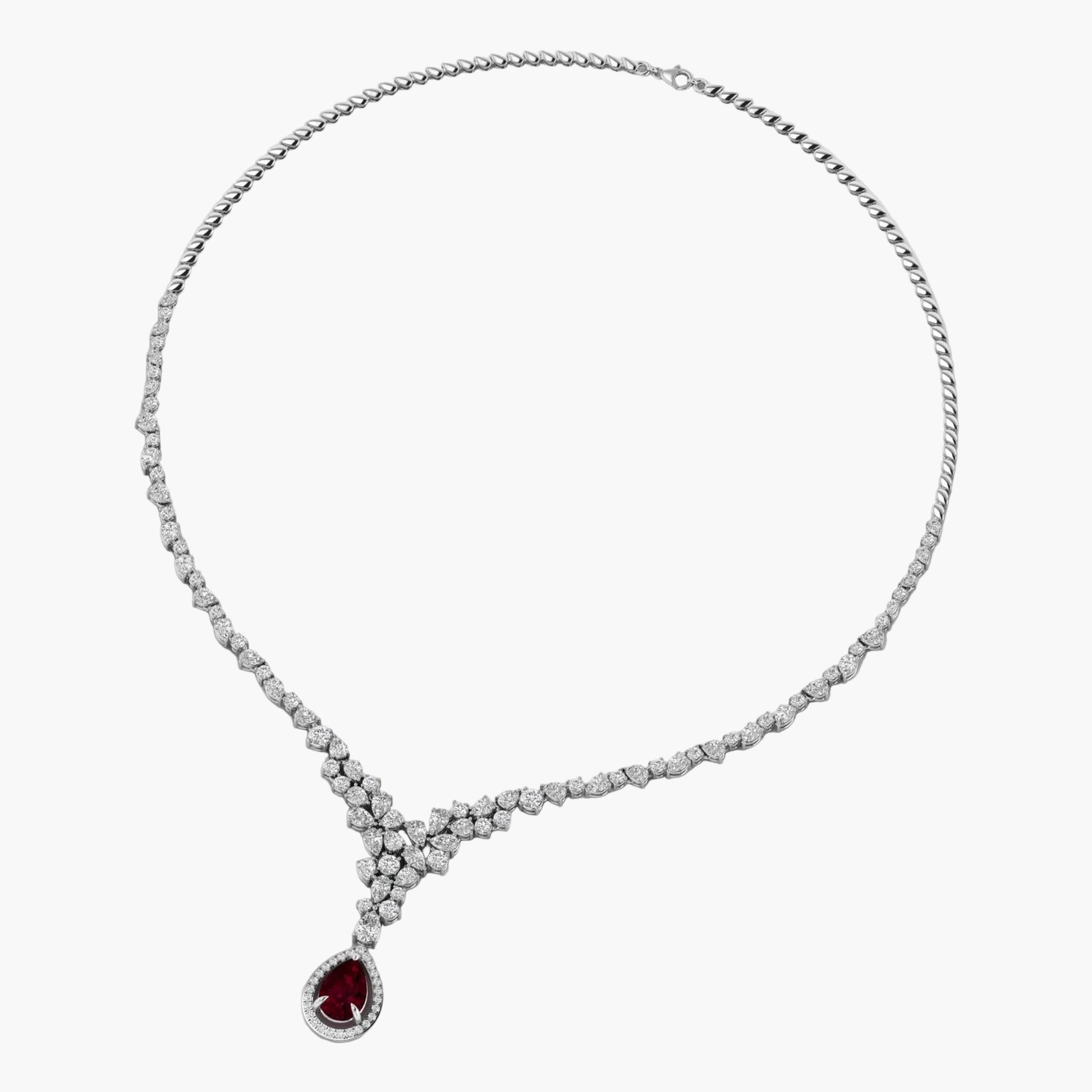 Diamond necklace with a red gemstone pendant on a white background
