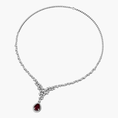 Diamond necklace with a red gemstone pendant on a white background