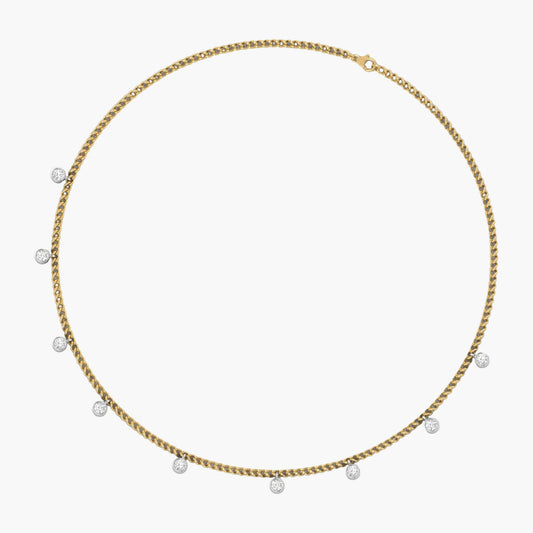 Gold chain necklace with small pearls on a white background