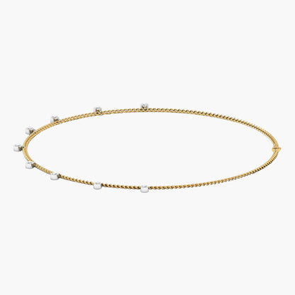 Gold necklace with small pearls on a white background