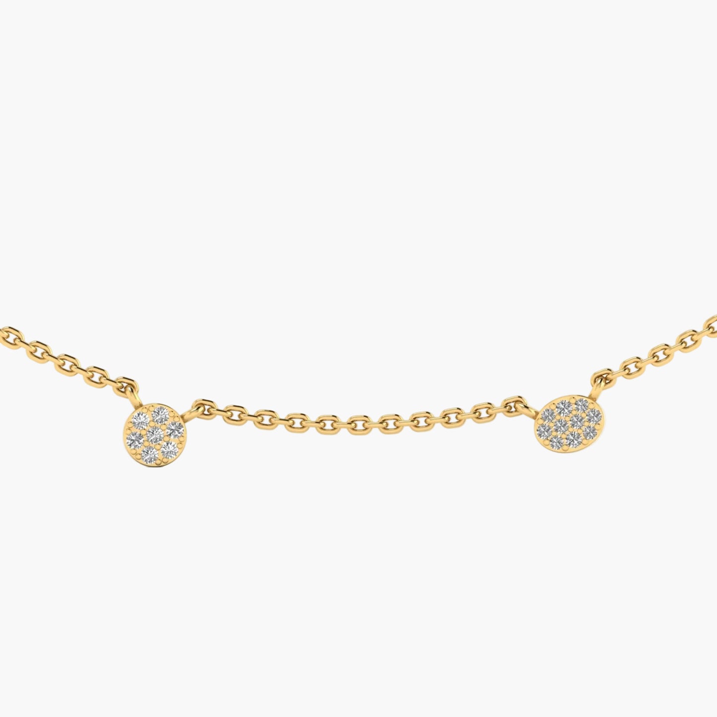 Gold necklace with small round pendants on a white background