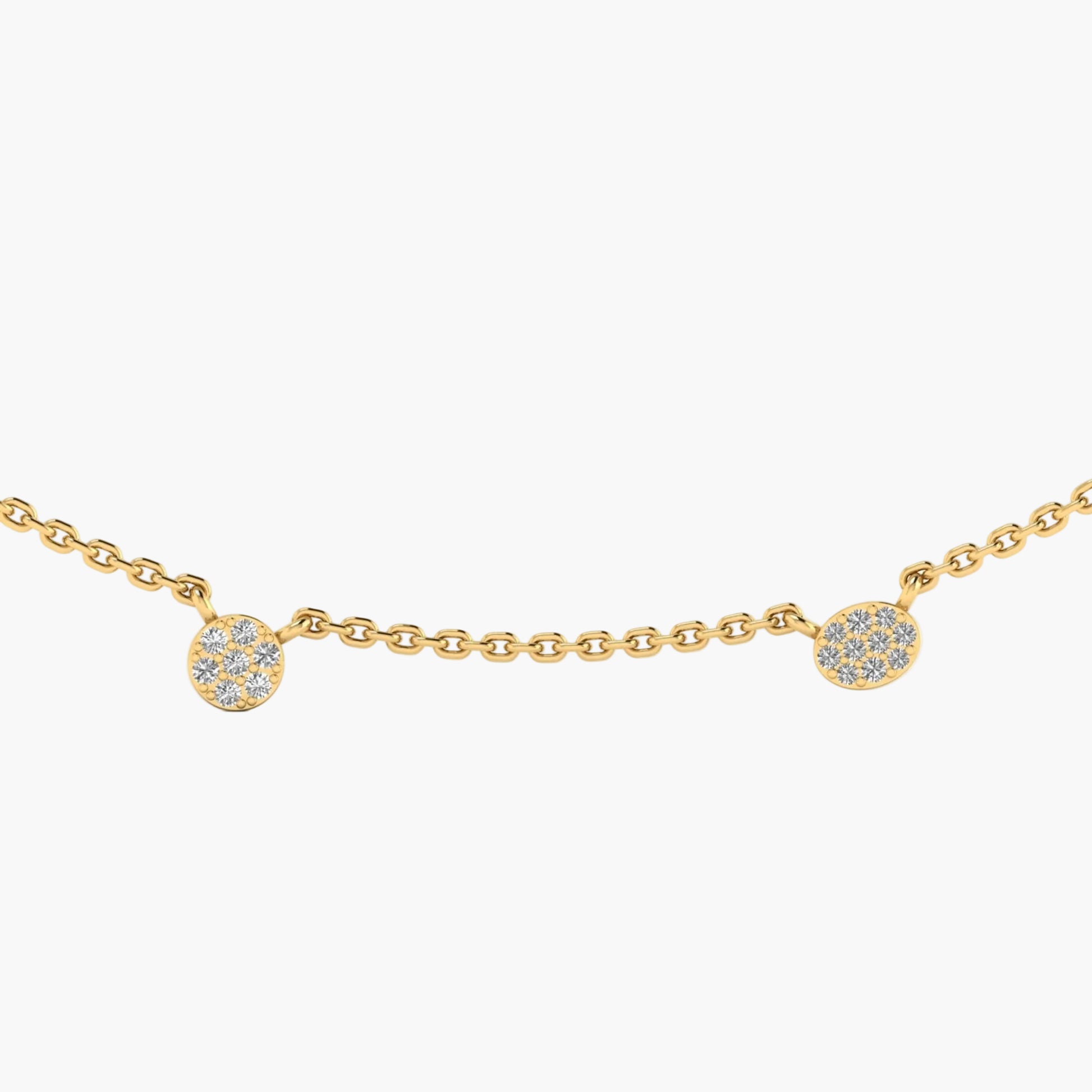 Gold necklace with small round pendants on a white background