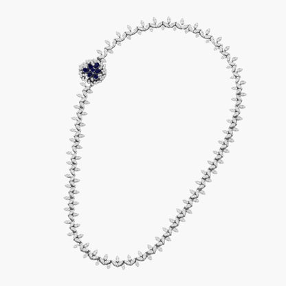 Silver beaded necklace with a blue gemstone on a white background