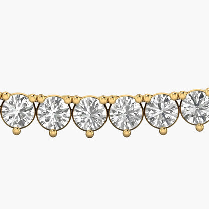 Gold bracelet with clear gemstones on a white background