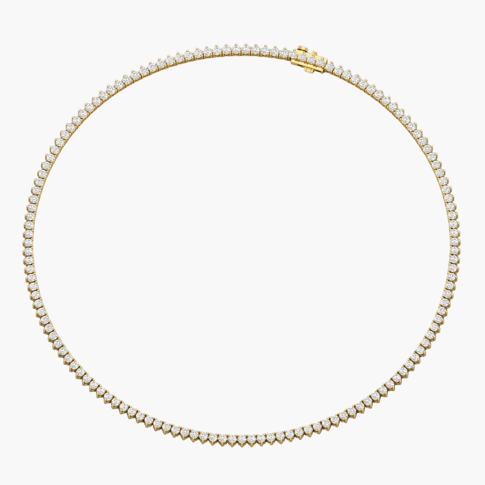 Gold necklace with clear stones on a white background