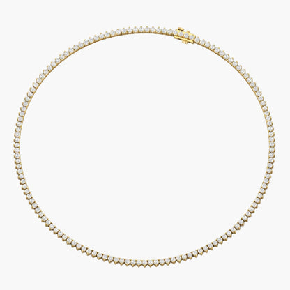 Gold necklace with clear stones on a white background