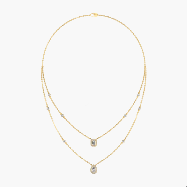 Gold necklace with green gemstones on a white background, featuring the brand 'Green Lab'.