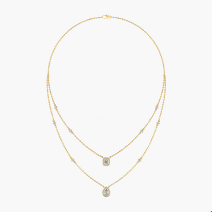 Gold necklace with green gemstones on a white background, featuring the brand 'Green Lab'.