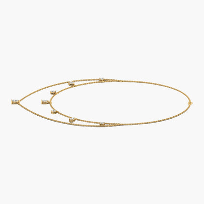 Gold necklace with small stones on a white background, branded 'Green Lab'.