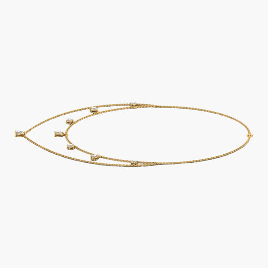 Gold necklace with small stones on a white background, branded 'Green Lab'.