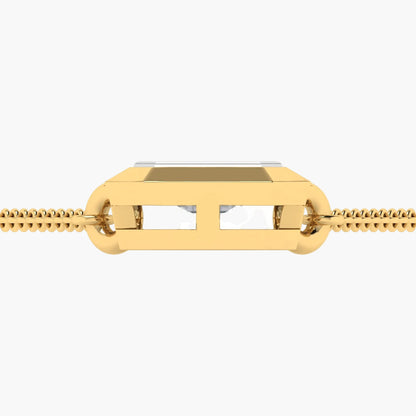 Gold chain with a rectangular pendant on a white background