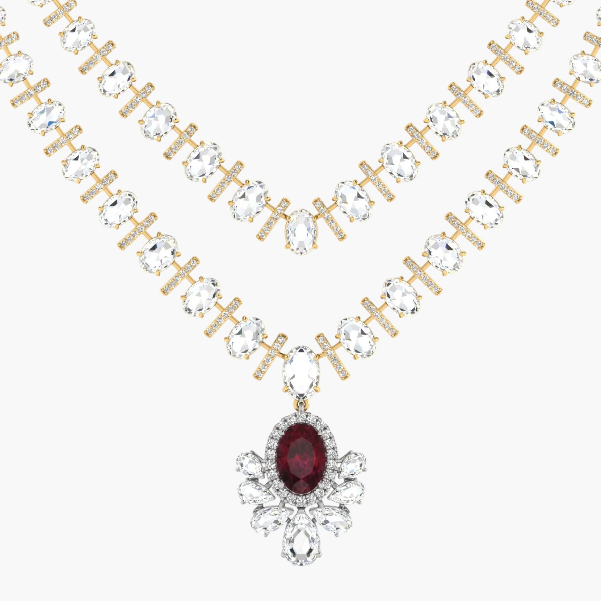 Gold necklace with clear gemstones and a red gemstone pendant on a white background