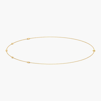 Gold necklace with small beads on a white background, branded 'Green Lab'.