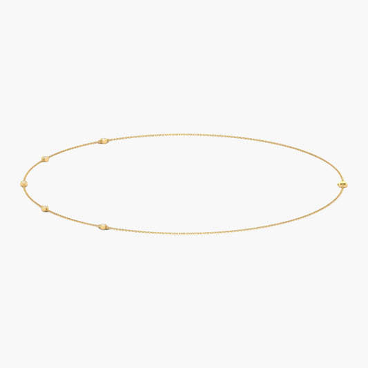 Gold necklace with small beads on a white background, branded 'Green Lab'.