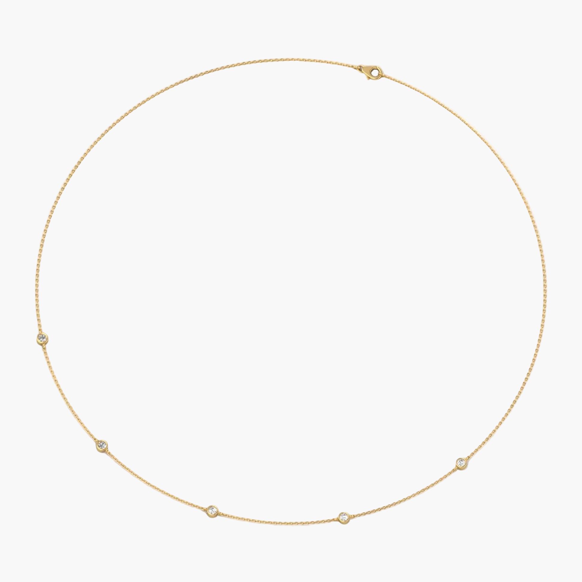 Gold necklace with small stones on a white background, branded 'Green Lab'.