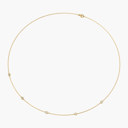 Gold necklace with small stones on a white background, branded 'Green Lab'.