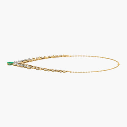 Gold necklace with green gemstone on a white background