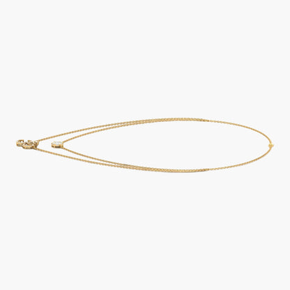 Gold necklace on a white background with 'Green Lab' branding.