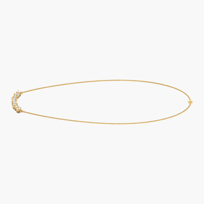 Gold necklace with small stones on a white background, branded 'Green Lab'.