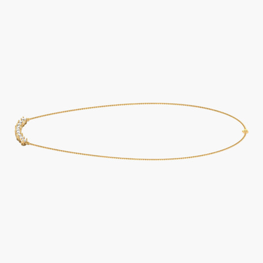 Gold necklace with small stones on a white background, branded 'Green Lab'.