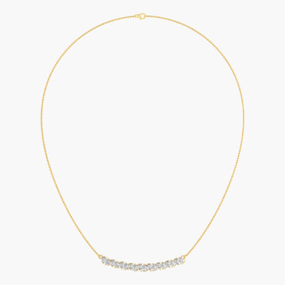 Gold necklace with small diamonds on a light gray background