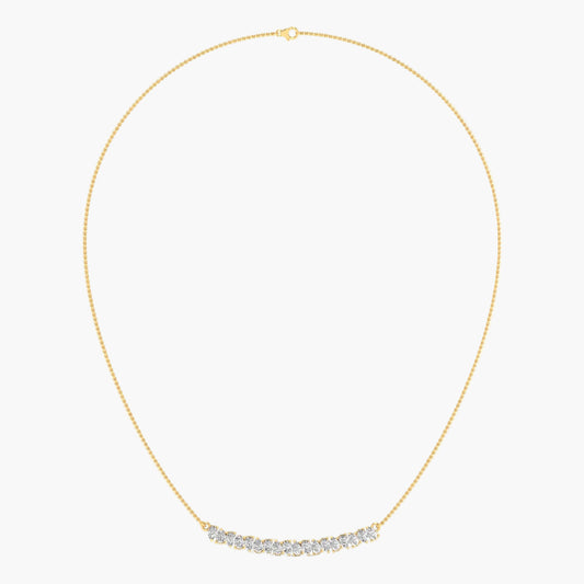 Gold necklace with small diamonds on a light gray background