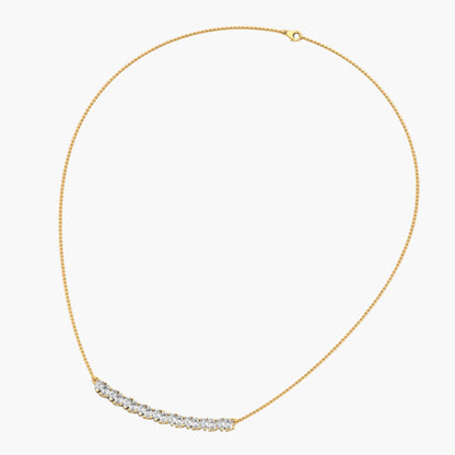 Gold necklace with a curved chain and small diamonds on a white background