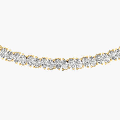 Gold bracelet with clear gemstones on a white background