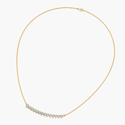 Gold necklace with a small diamond pendant on a white background