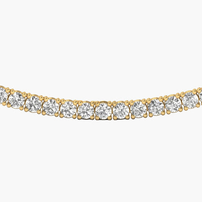 Gold necklace with clear gemstones on a white background