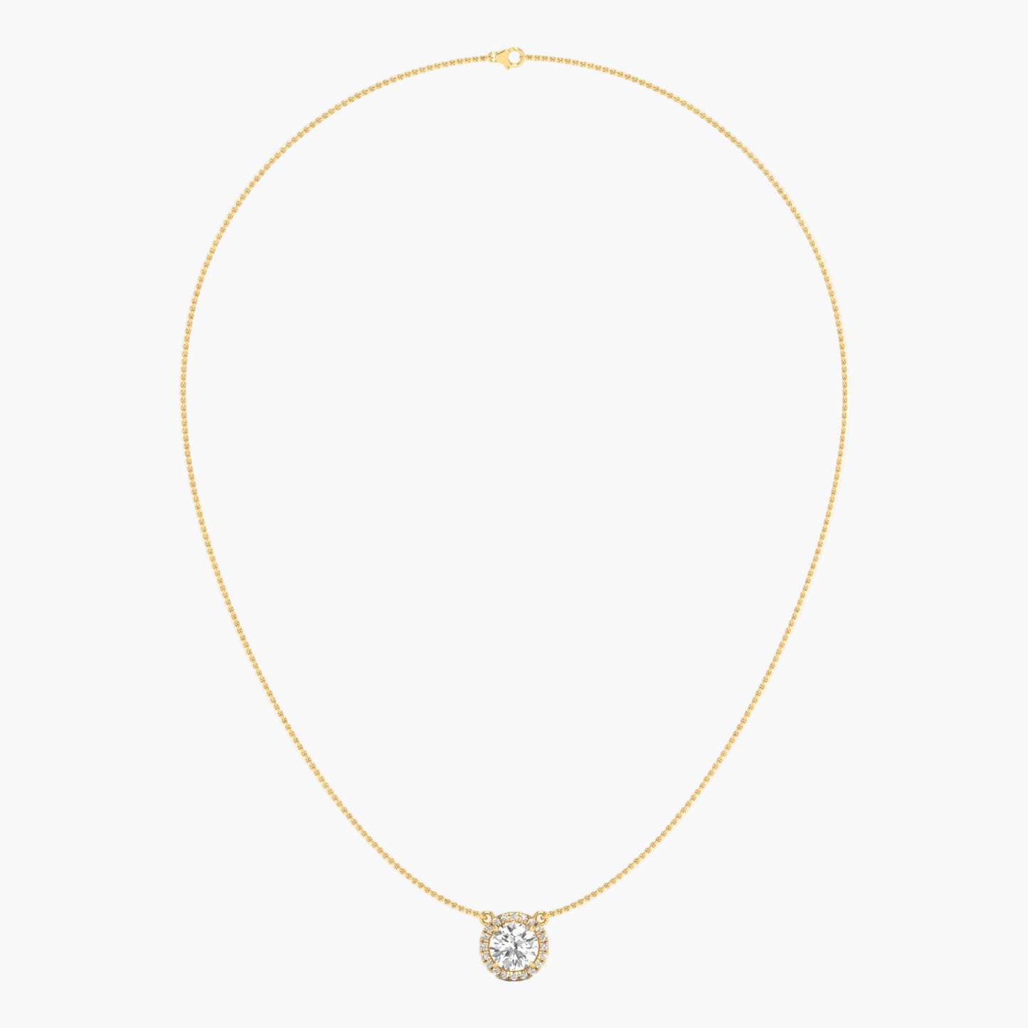 Gold necklace with a round pendant on a light beige background