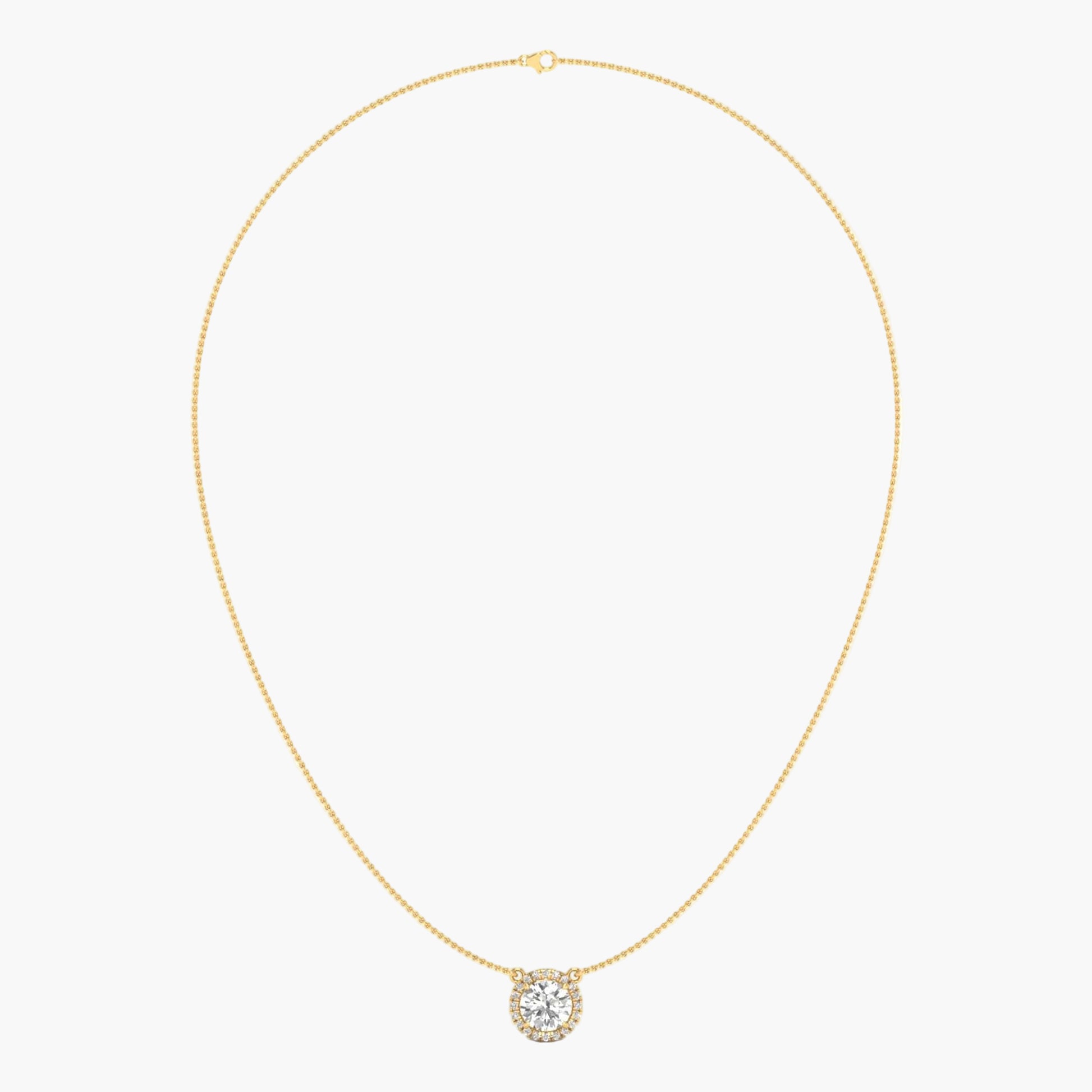 Gold necklace with a round pendant on a light beige background