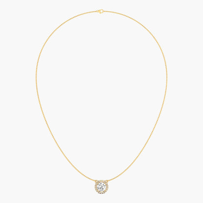Gold necklace with a round pendant on a light beige background
