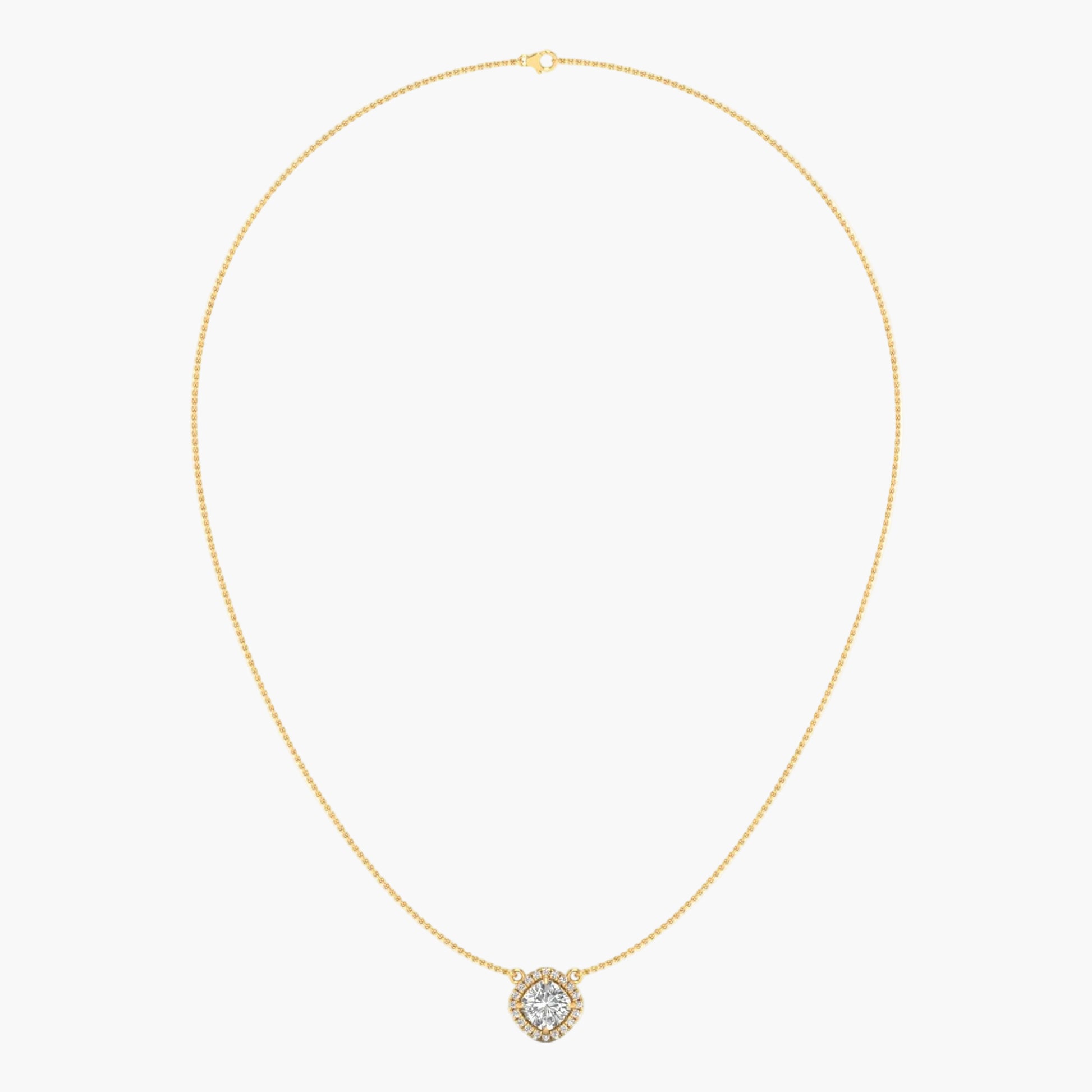 Gold necklace with a small round pendant on a light beige background