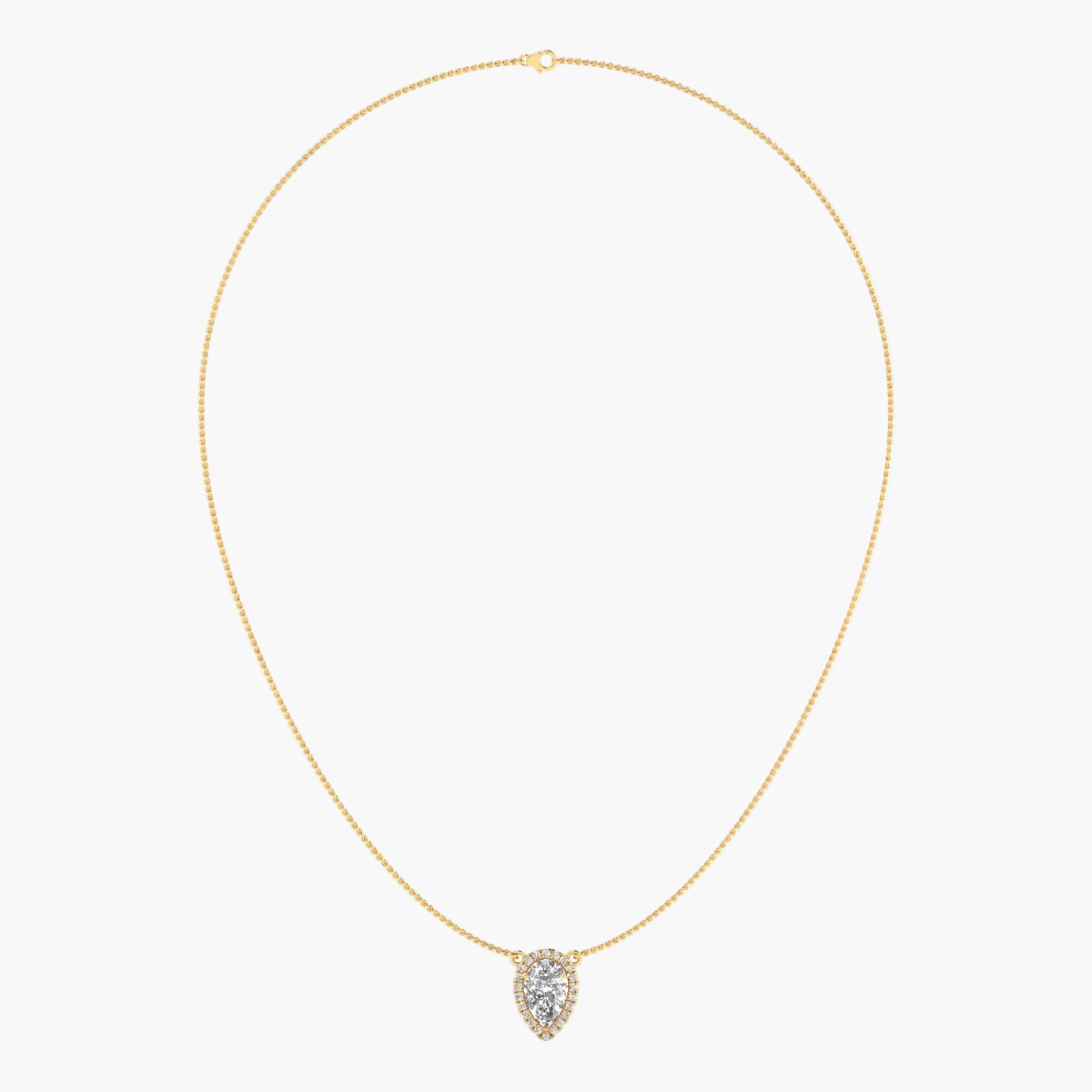Gold necklace with a heart-shaped pendant on a light beige background