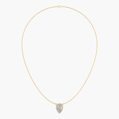Gold necklace with a heart-shaped pendant on a light beige background