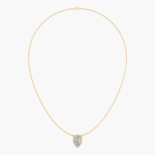 Gold necklace with a heart-shaped pendant on a light beige background