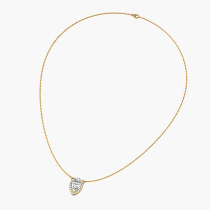 Gold necklace with a heart-shaped diamond pendant on a white background