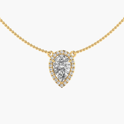 Gold necklace with a teardrop-shaped diamond pendant on a white background