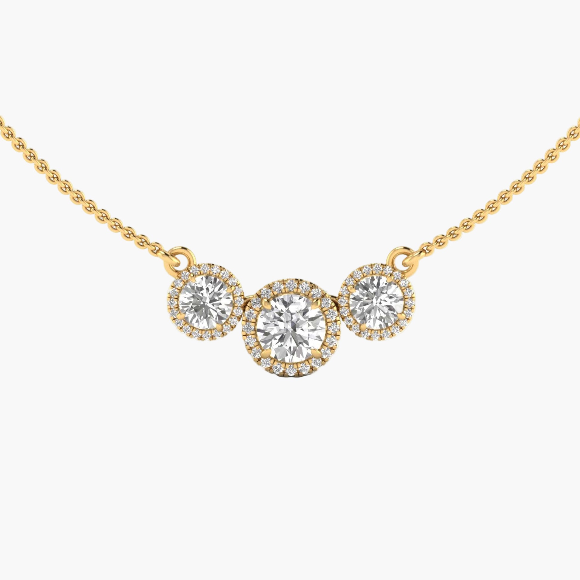Gold necklace with three round diamonds on a white background