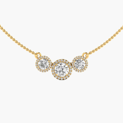 Gold necklace with three round diamonds on a white background