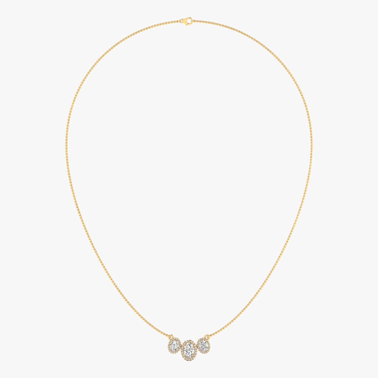 Gold necklace with a small pendant on a light gray background