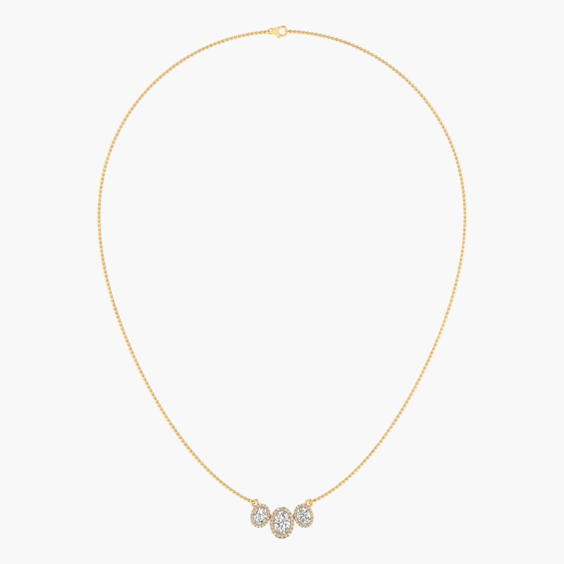 Gold necklace with a small pendant on a light gray background